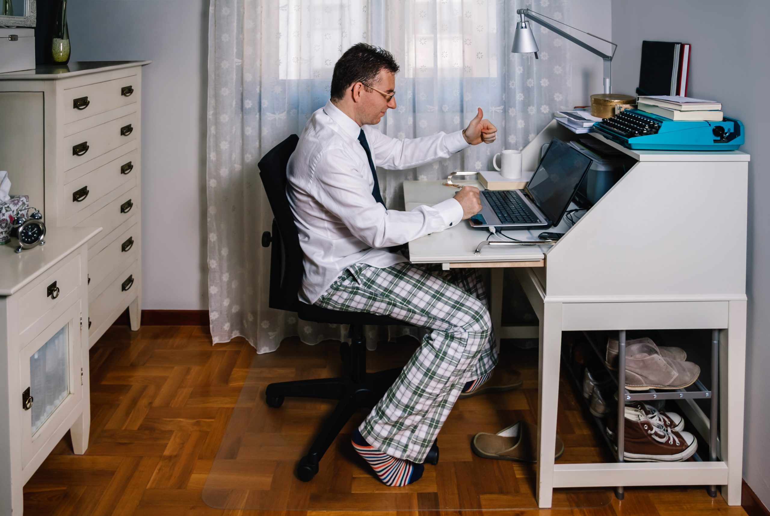 Man at desk in pajams and shirt and tie