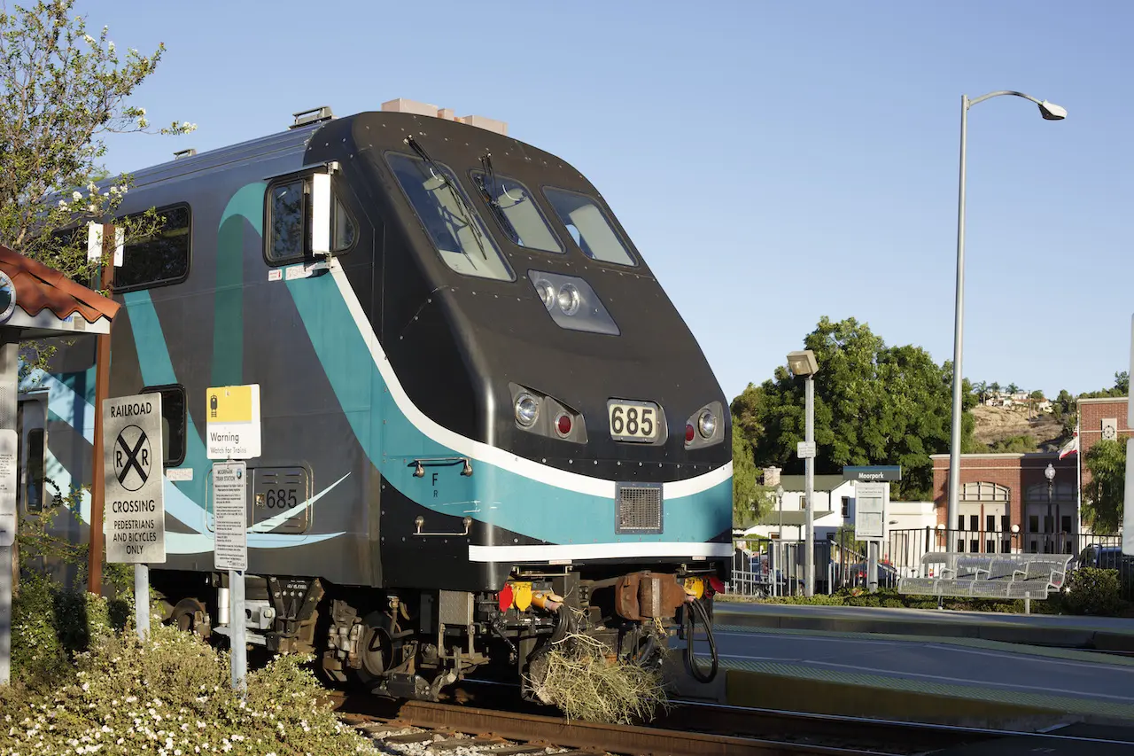 A sleek modern train at Goventura Staging station with clear blue sky.