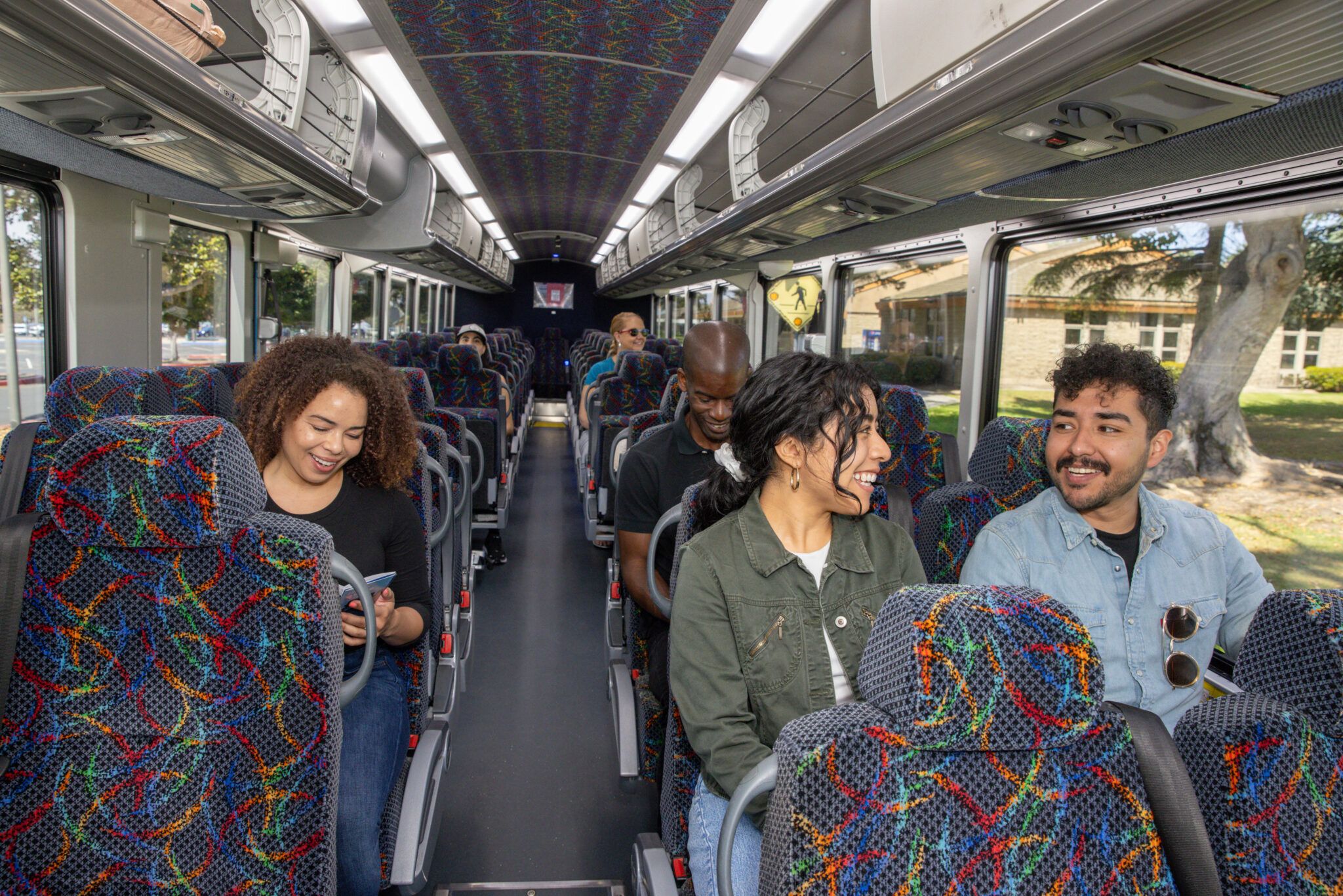 People sitting on VCTC coach smiling