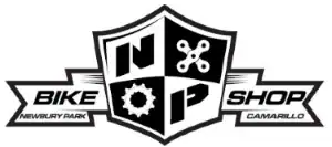 Bike shop logo featuring a shield with gear, wrench, and bike icons, Newbury Park.
