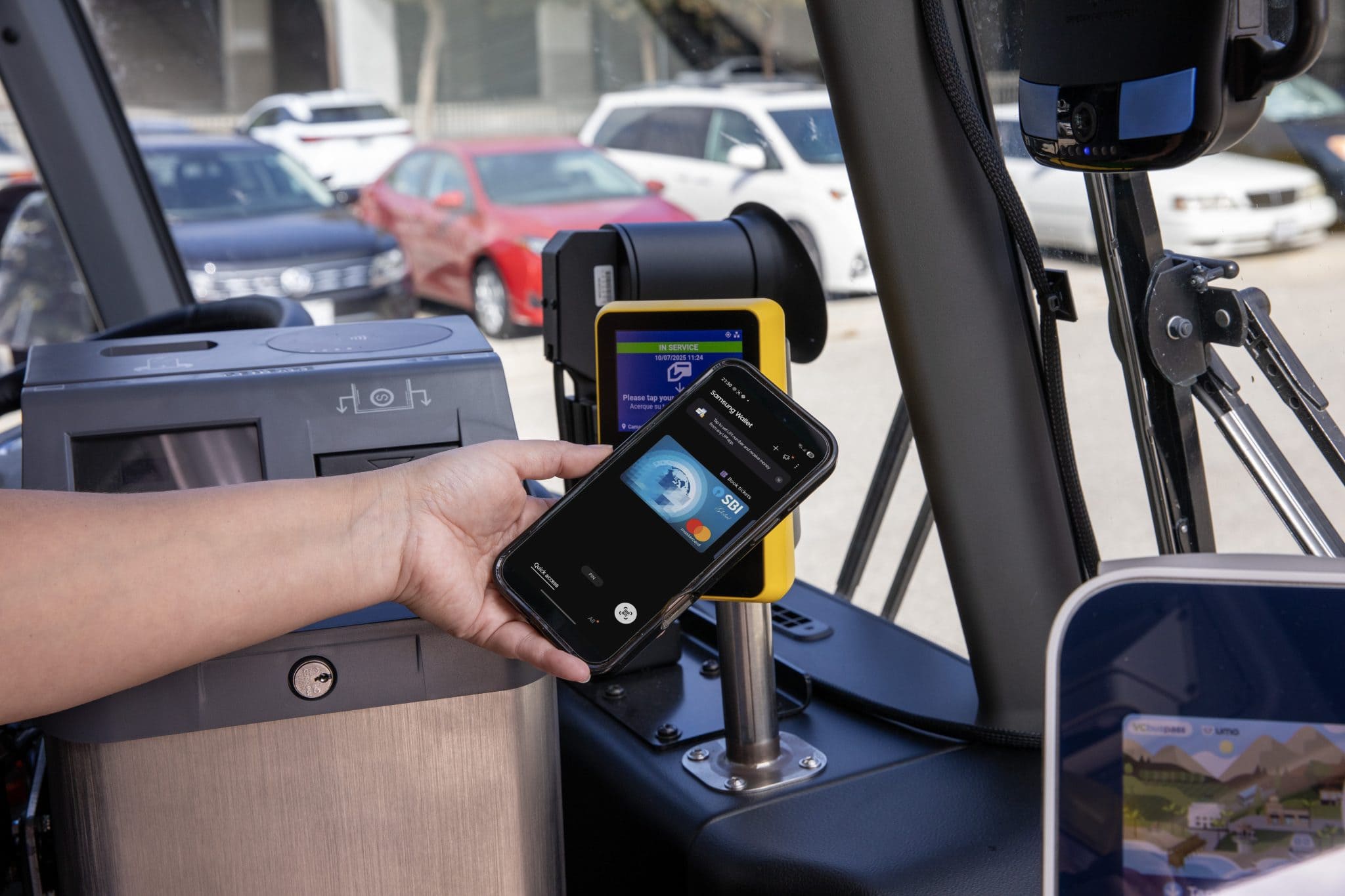 Person paying for trip using tap 2 ride and her phone