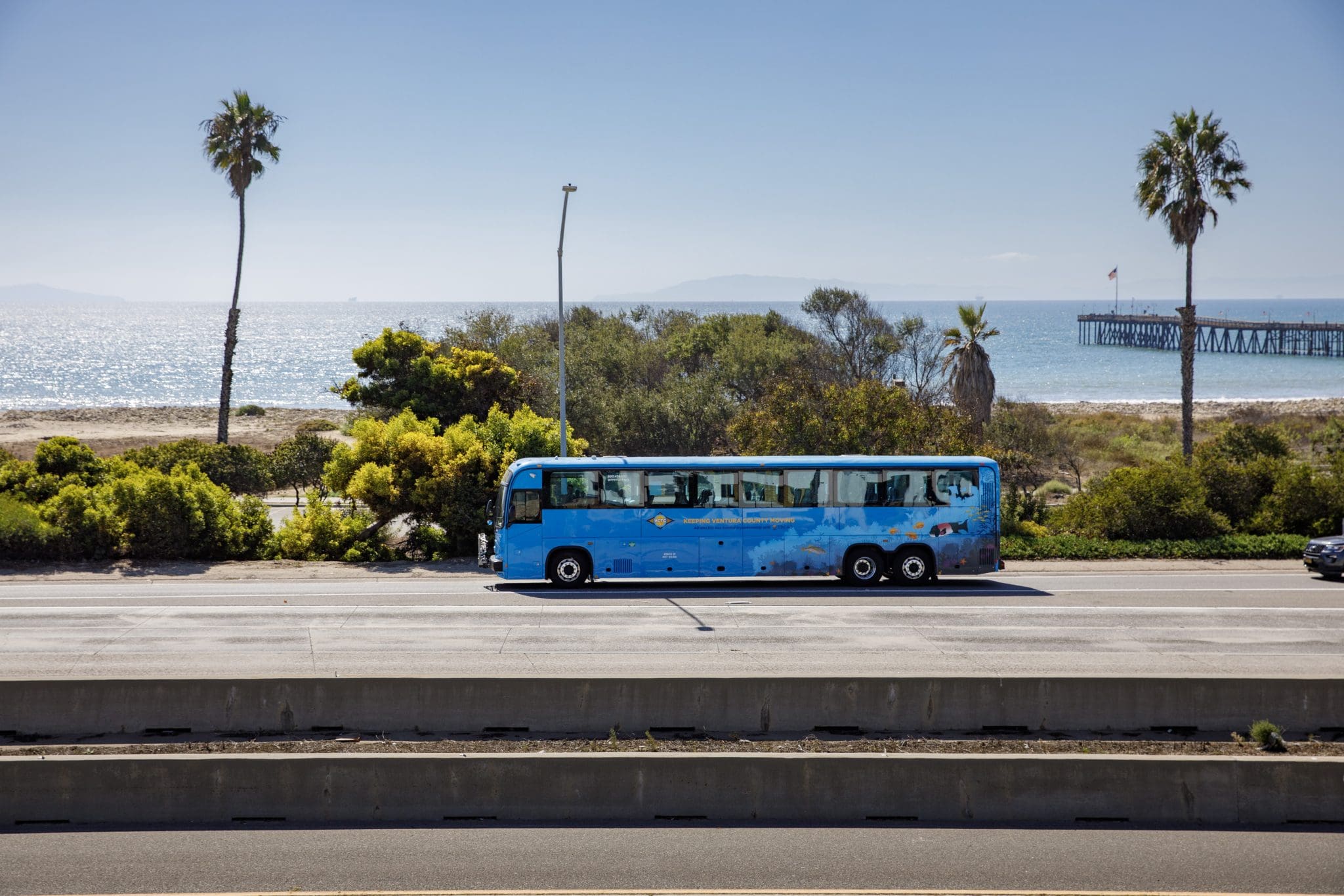 VCTC coach driving on highway wit beach in the background